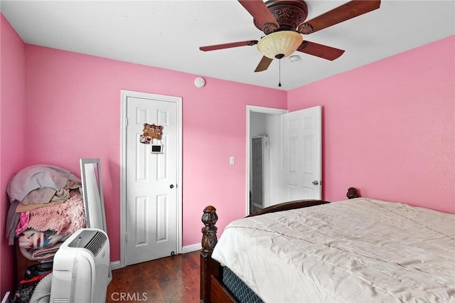 bedroom featuring ceiling fan and dark wood-type flooring