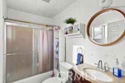 full bathroom featuring vanity, toilet, and shower / tub combo with curtain