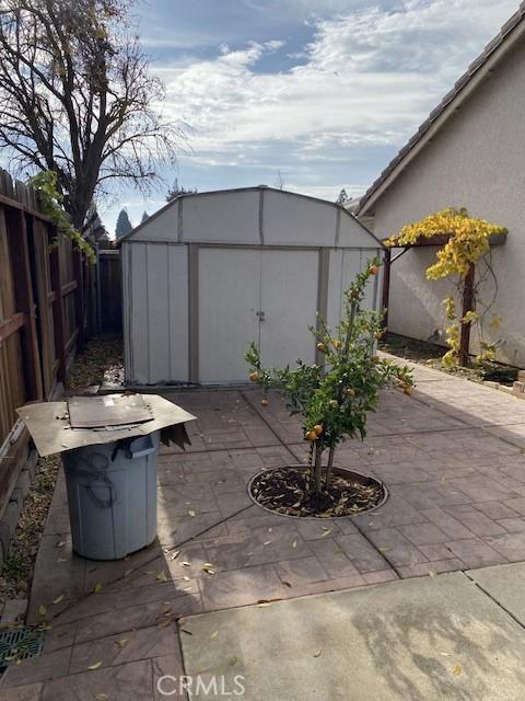 view of patio / terrace with a shed