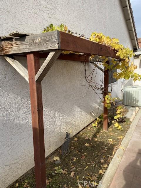 view of side of home with central AC unit