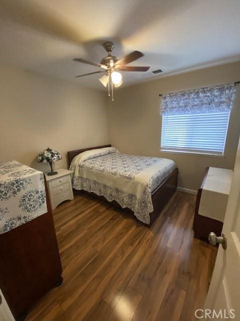 bedroom with ceiling fan and dark hardwood / wood-style floors