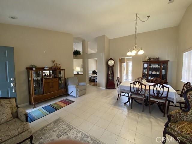 dining room with light tile patterned flooring and a chandelier