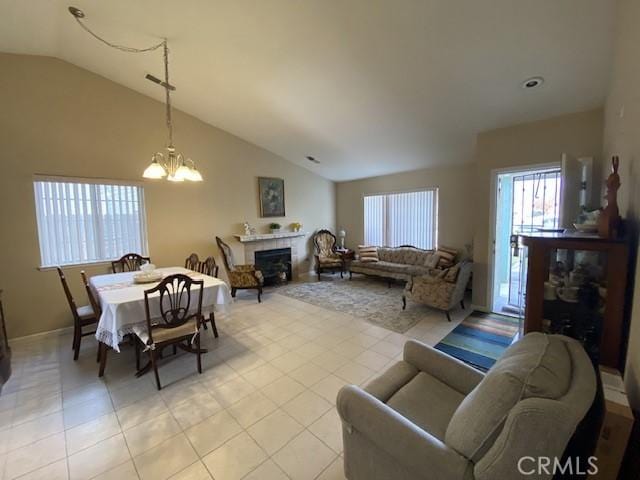 living room featuring lofted ceiling, a notable chandelier, and light tile patterned flooring