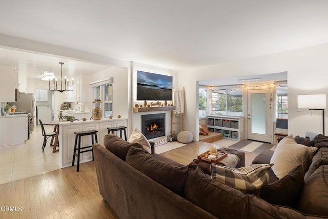 living room with light wood-type flooring and a chandelier