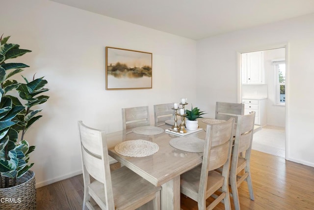 dining space with light wood-type flooring