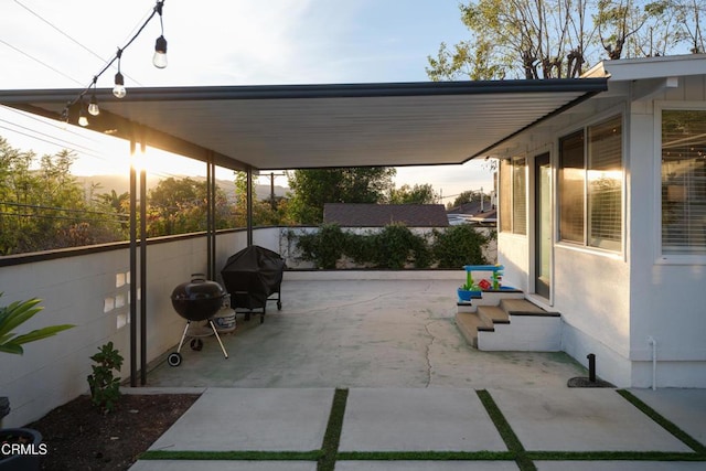 patio terrace at dusk with a grill