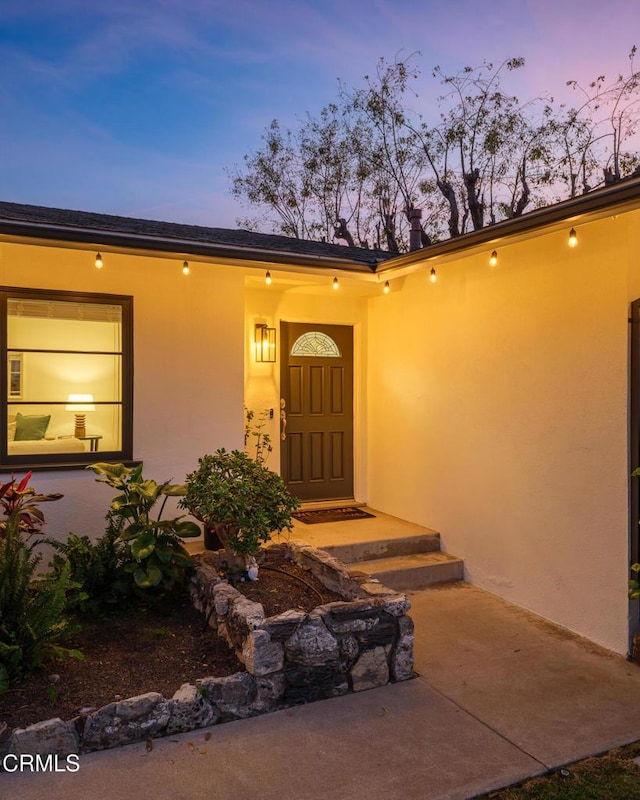 view of exterior entry at dusk