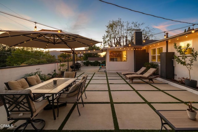 view of patio terrace at dusk