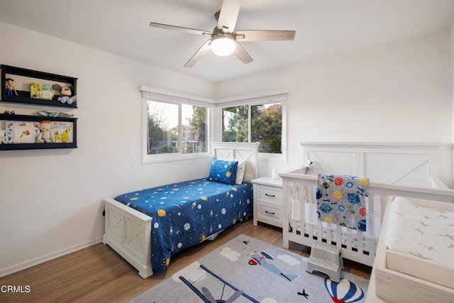 bedroom with ceiling fan and dark hardwood / wood-style flooring