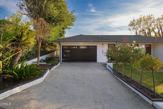 view of front of property with a front yard and a garage