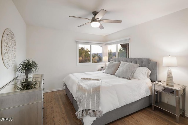 bedroom with ceiling fan and dark wood-type flooring