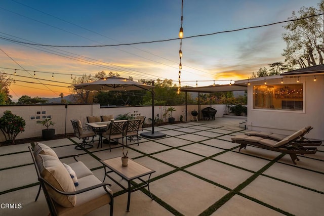 patio terrace at dusk featuring outdoor lounge area