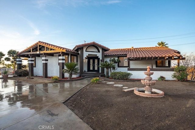 mediterranean / spanish-style house with french doors