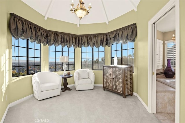 living area featuring light colored carpet, beamed ceiling, and an inviting chandelier