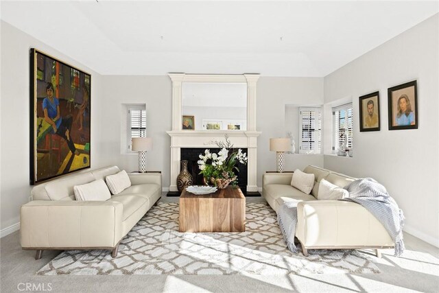 living room featuring a tray ceiling and light carpet