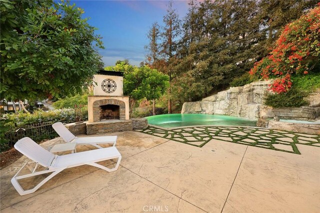 view of patio / terrace with an outdoor stone fireplace