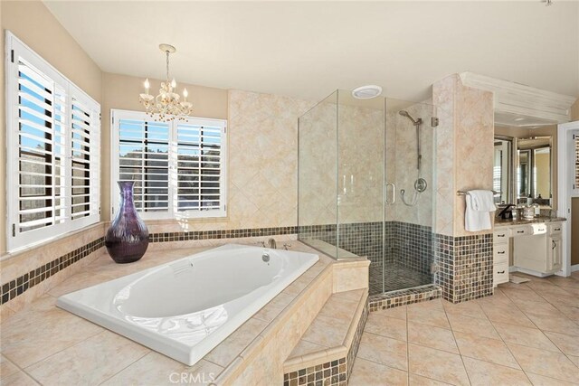 bathroom featuring tile patterned flooring, vanity, a notable chandelier, and plus walk in shower