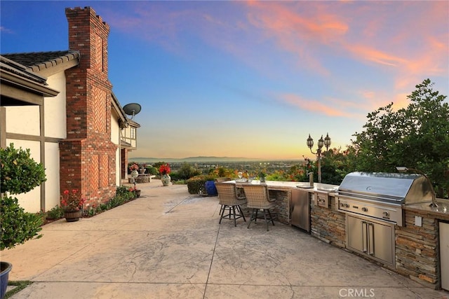 patio terrace at dusk with area for grilling