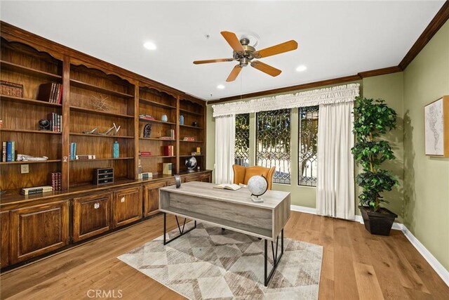 office space featuring ceiling fan, light wood-type flooring, and ornamental molding