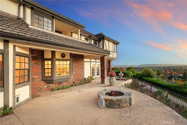 patio terrace at dusk with a fire pit