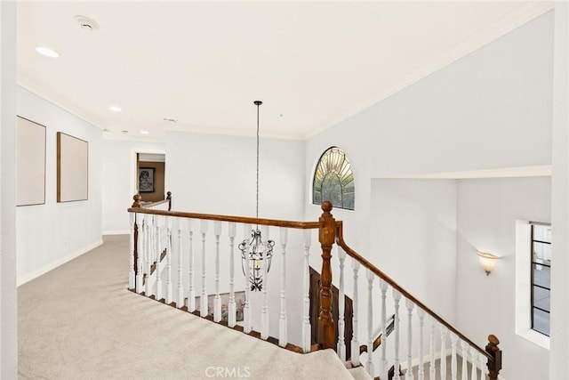 hall with light carpet and ornamental molding