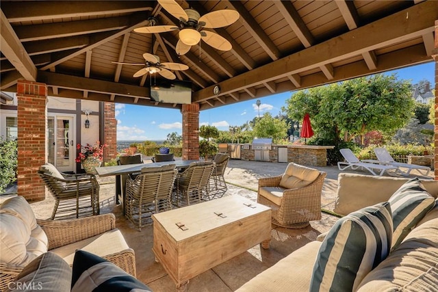 view of patio with ceiling fan, a gazebo, an outdoor living space, and area for grilling