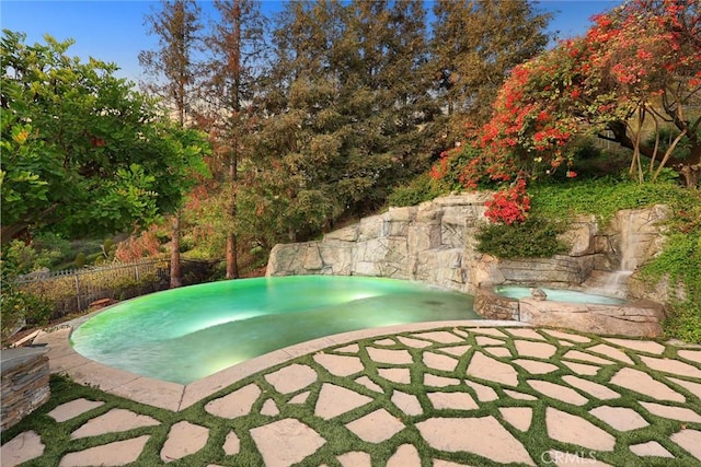 view of pool with an in ground hot tub and a patio