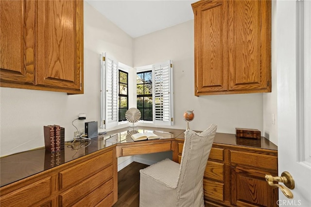 office area featuring built in desk and dark hardwood / wood-style flooring