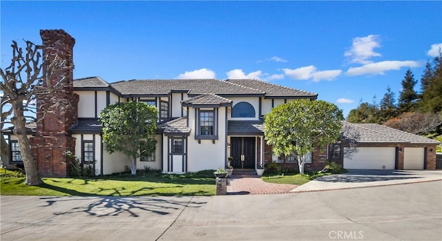 view of front of home with a front lawn and a garage