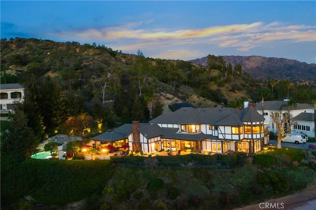 back house at dusk featuring a mountain view