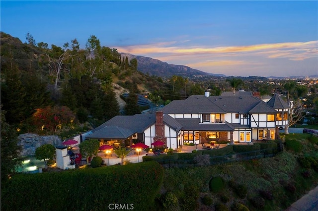 back house at dusk with a mountain view