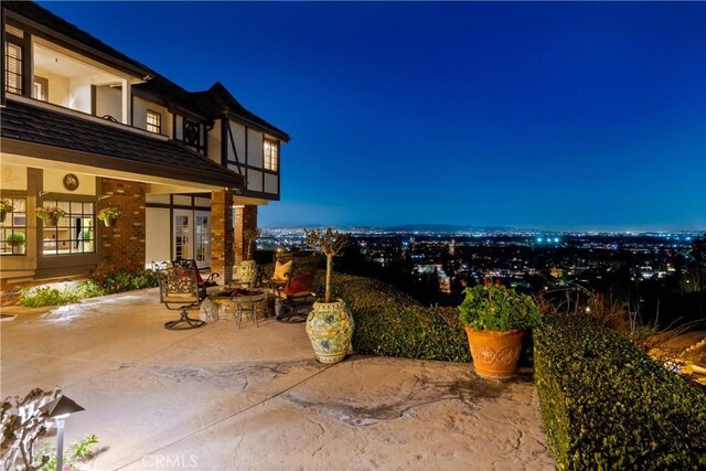 patio at night featuring a fire pit