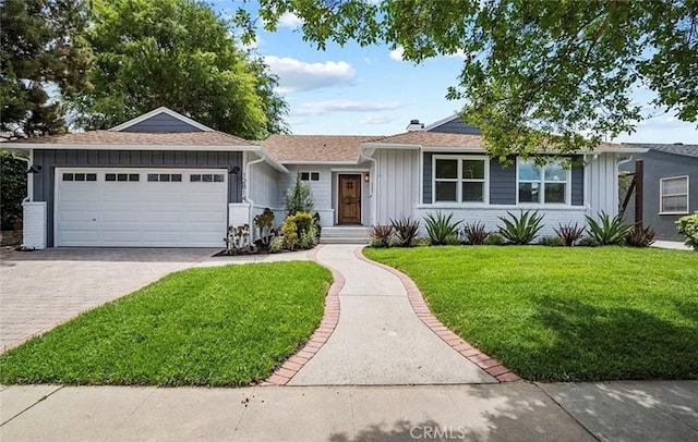 ranch-style home with a garage and a front yard