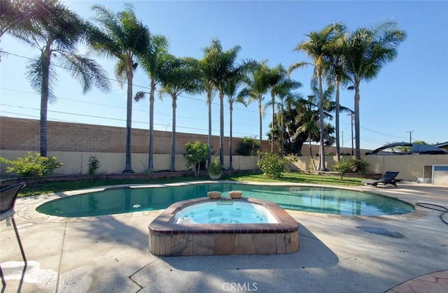 view of pool with an in ground hot tub and a patio