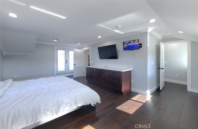 bedroom with dark hardwood / wood-style floors, lofted ceiling, crown molding, and french doors