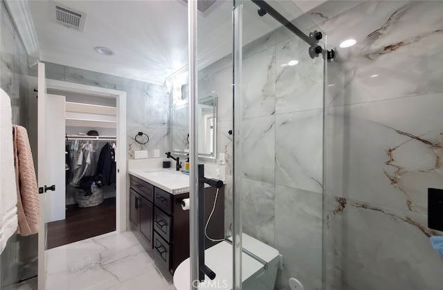 bathroom featuring vanity, an enclosed shower, and tile walls