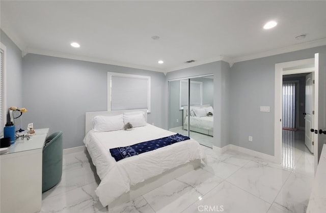 bedroom with crown molding and a closet