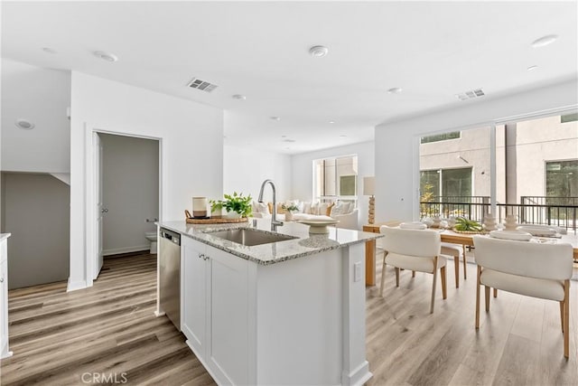 9431 N Sepulveda Blvd Unit 3, North Hills, CA 91343 - kitchen with open floor plan, stainless steel dishwasher, light wood-type flooring, light stone counters, and recessed lighting
