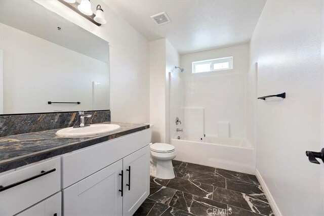 full bathroom featuring vanity, toilet, and washtub / shower combination