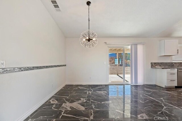 unfurnished dining area with a chandelier