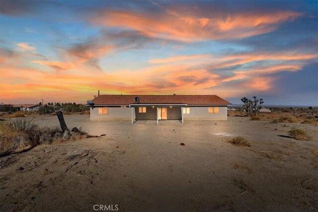 view of back house at dusk