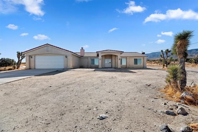 view of front of house featuring a mountain view and a garage