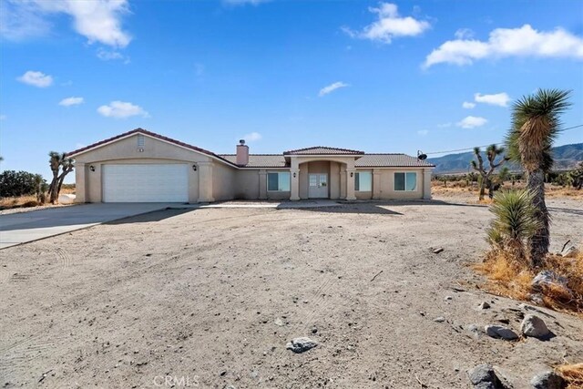 view of front of house with a garage and a mountain view