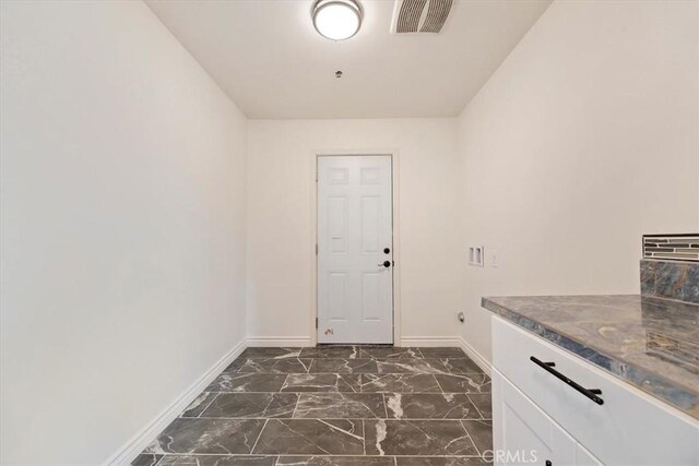 washroom with cabinets and hookup for a washing machine