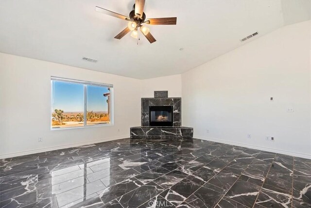 living room with ceiling fan, a fireplace, and vaulted ceiling