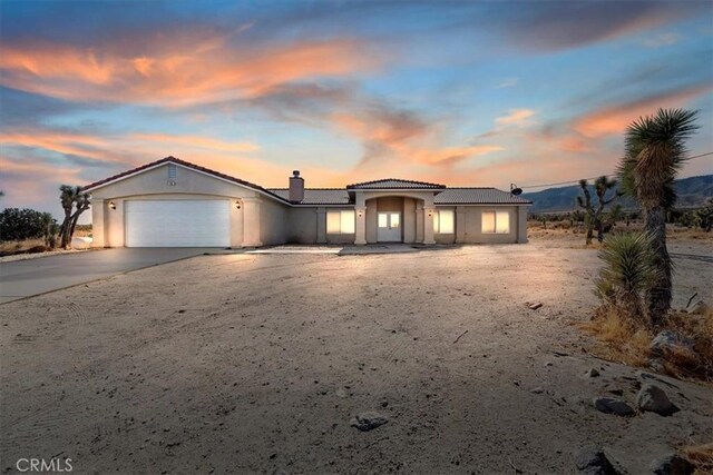 view of front of house with a mountain view and a garage