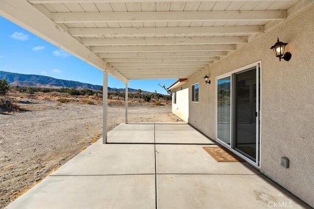 view of patio / terrace featuring a mountain view