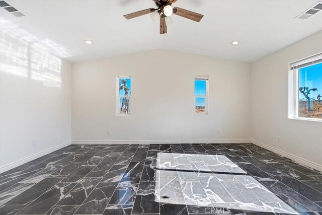 unfurnished room with ceiling fan and vaulted ceiling