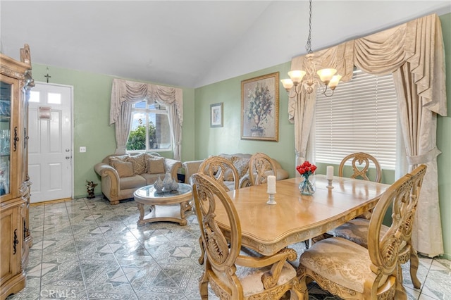 dining area with lofted ceiling and a chandelier