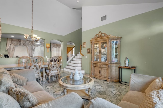 living room featuring high vaulted ceiling and a chandelier